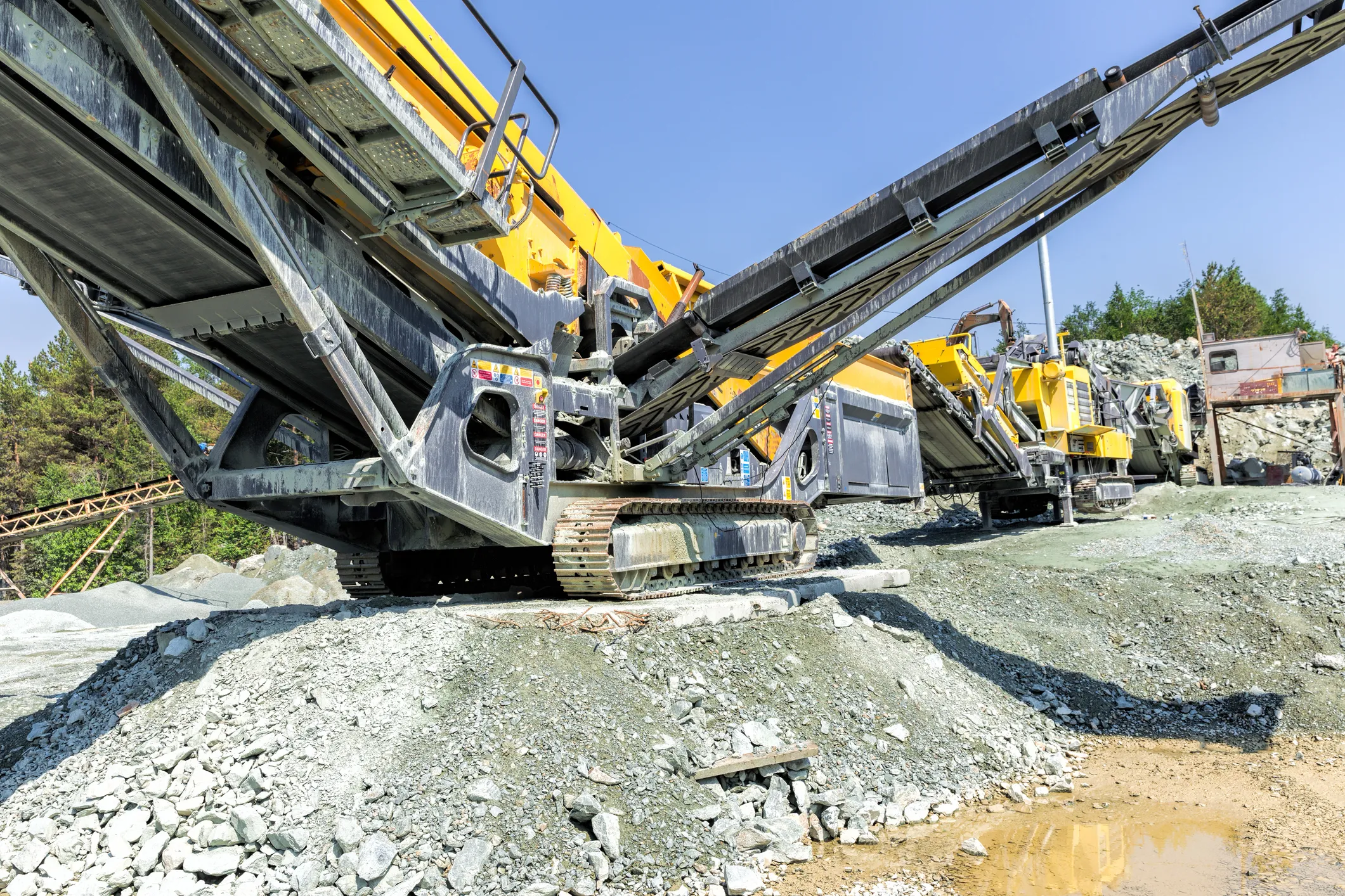 Cement and concrete construction site in Guyana with oil and gas infrastructure in the background.